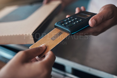 Buy stock photo Cropped shot of an unrecognizable woman using a credit card machine to pay for her meal at a restaurant