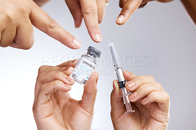 Buy stock photo Studio shot of a group of people showing thumbs up and holding the vaccine against a grey background