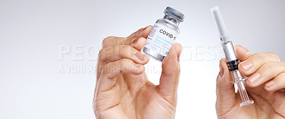 Buy stock photo Shot of a unrecognizable person holding the vaccine against a grey background