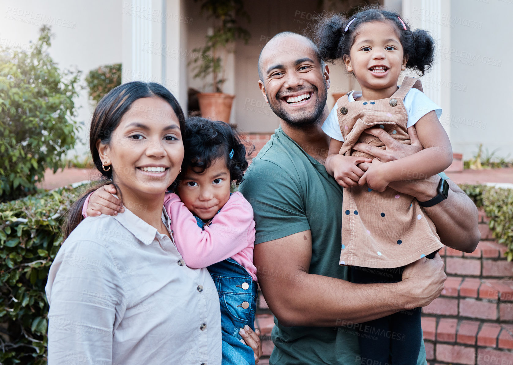 Buy stock photo Shot of a couple spending time outside with their two daughters