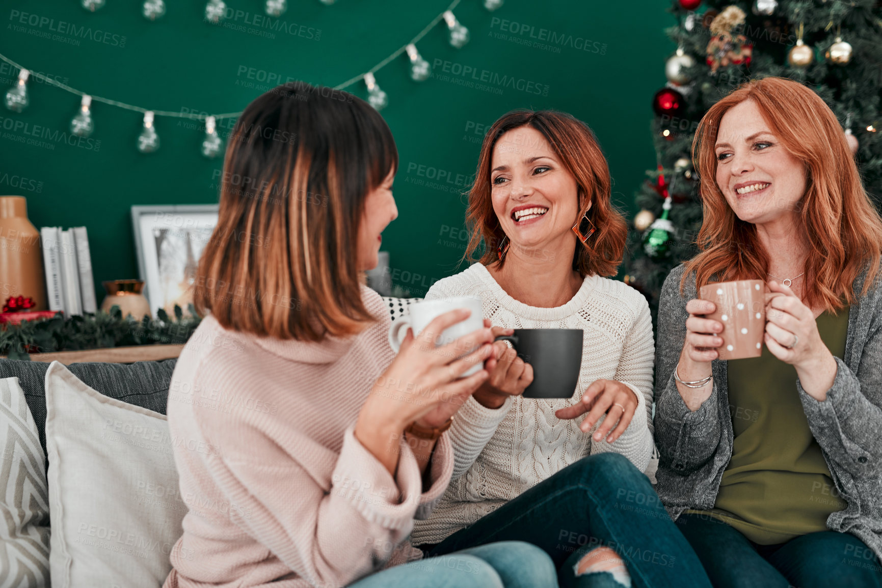 Buy stock photo Coffee, friends and women on sofa for Christmas celebration and talking together for vacation reunion. Female people, group and smile with hot chocolate drink for happy conversation and festive decor