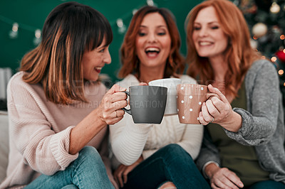 Buy stock photo Shot of three attractive women having a coffee on the sofa together at home