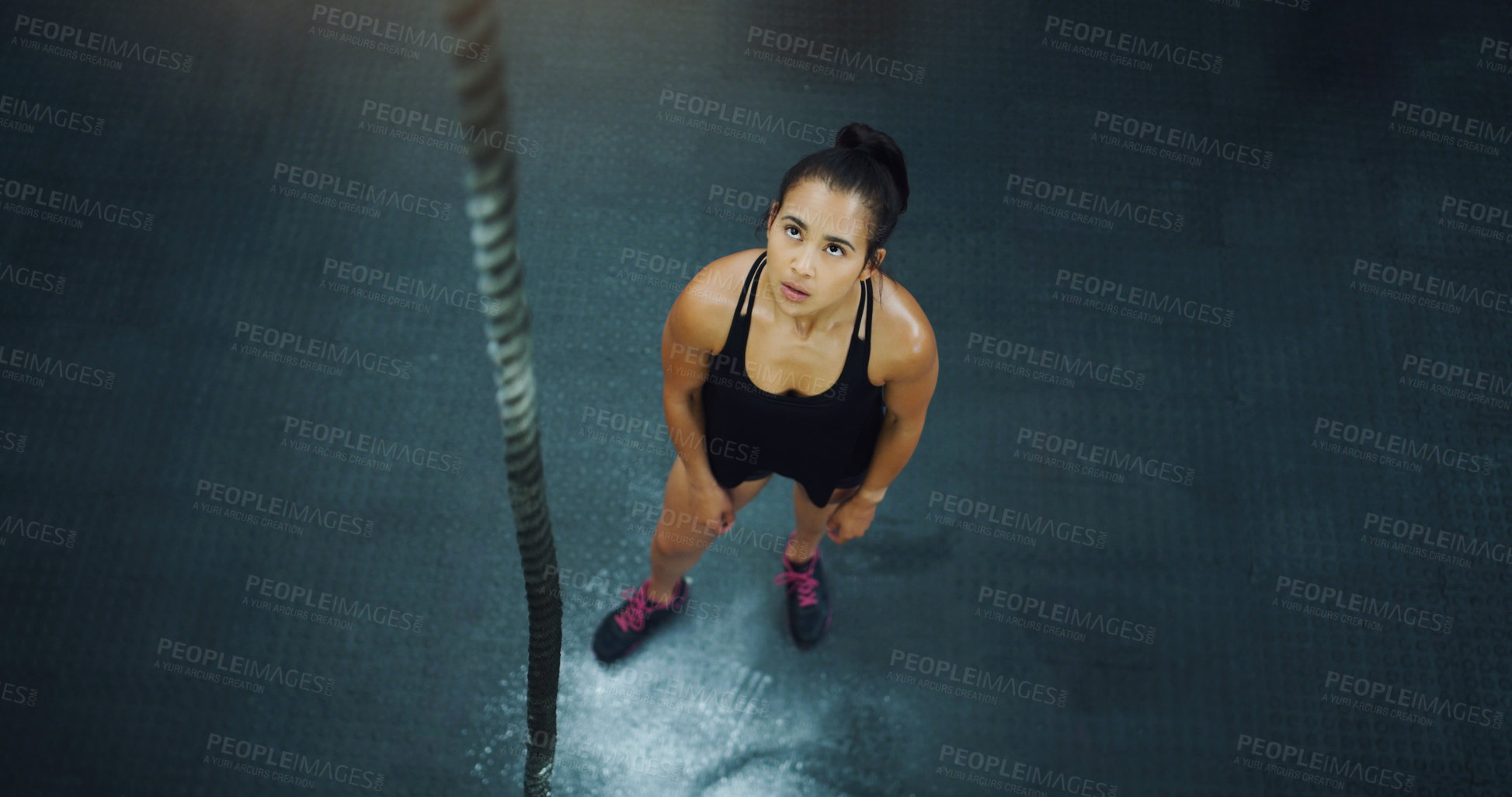 Buy stock photo Rope climbing, woman and fitness at gym from above for training, performance and intense cardio on black background. Top view, climb and female with ropes, resilience and mindset during power workout