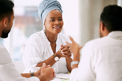 Buy stock photo Shot of businesspeople having a meeting in a boardroom at work