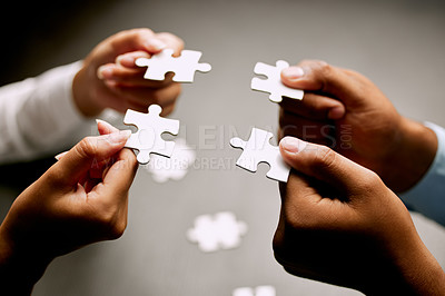 Buy stock photo Closeup shot of a group of unrecognizable businesspeople holding puzzle pieces together