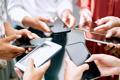 Buy stock photo Cropped shot of a group of unrecignizable businesspeople using their smart phones in synchronicity