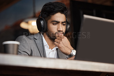 Buy stock photo Young business man, thinking and coffee shop with headphones, laptop or plan for schedule, report or analysis. Indian businessman, solution and ideas with brainstorming, web design and music in cafe
