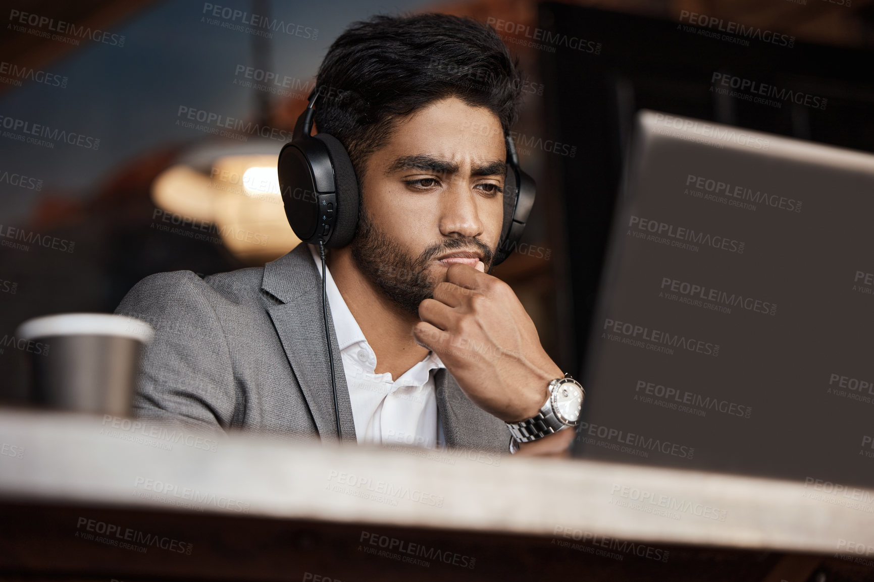 Buy stock photo Young business man, thinking and coffee shop with headphones, laptop or plan for schedule, report or analysis. Indian businessman, solution and ideas with brainstorming, web design and music in cafe