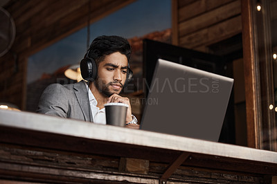 Buy stock photo Shot of a young businessman working in a cafe
