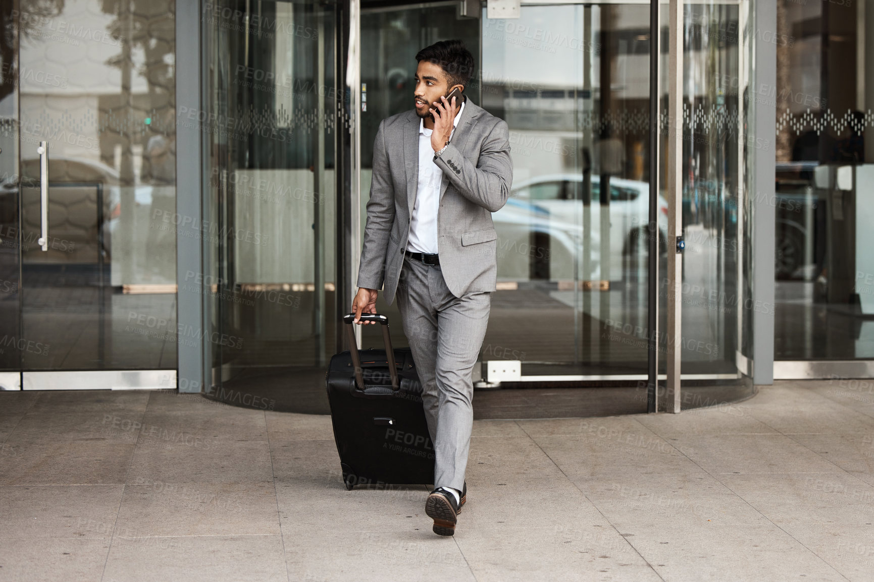 Buy stock photo Phone call, travel and luggage with a business man walking in the city for an international trip. Mobile, communication and suitcase with a young male employee talking while on a global commute