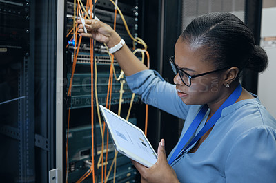 Buy stock photo Cropped shot of an attractive female programmer working on a tablet in a server room