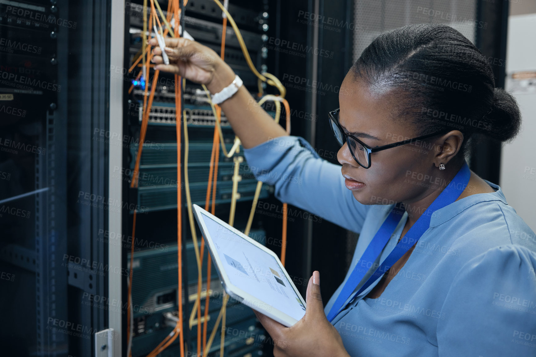 Buy stock photo Cropped shot of an attractive female programmer working on a tablet in a server room