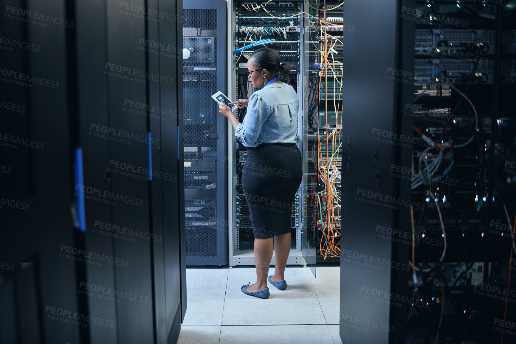 Buy stock photo Woman, server room and engineer with a tablet for programming, system upgrade or cable maintenance. Black female technician in datacenter for network, software download or cybersecurity with IT app