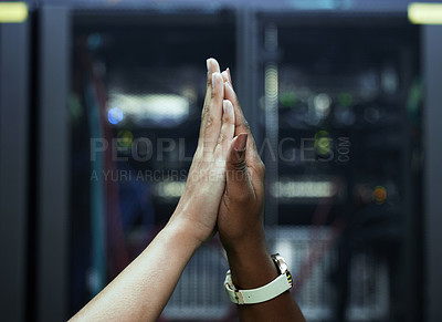 Buy stock photo Cropped shot of two unrecognizable female programmers high fiving in a server room