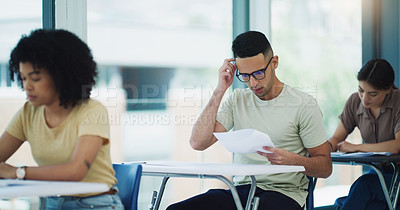 Buy stock photo Thinking, man and education test in a classroom with writing and student learning at a university. College exam, school and male person planning with document in a lecture hall with stress and paper
