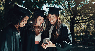 Buy stock photo Students, phone and achievement for graduation outdoor with social media, academic success and reading text. Women, outside and graduate together with mobile for university, online chat and education