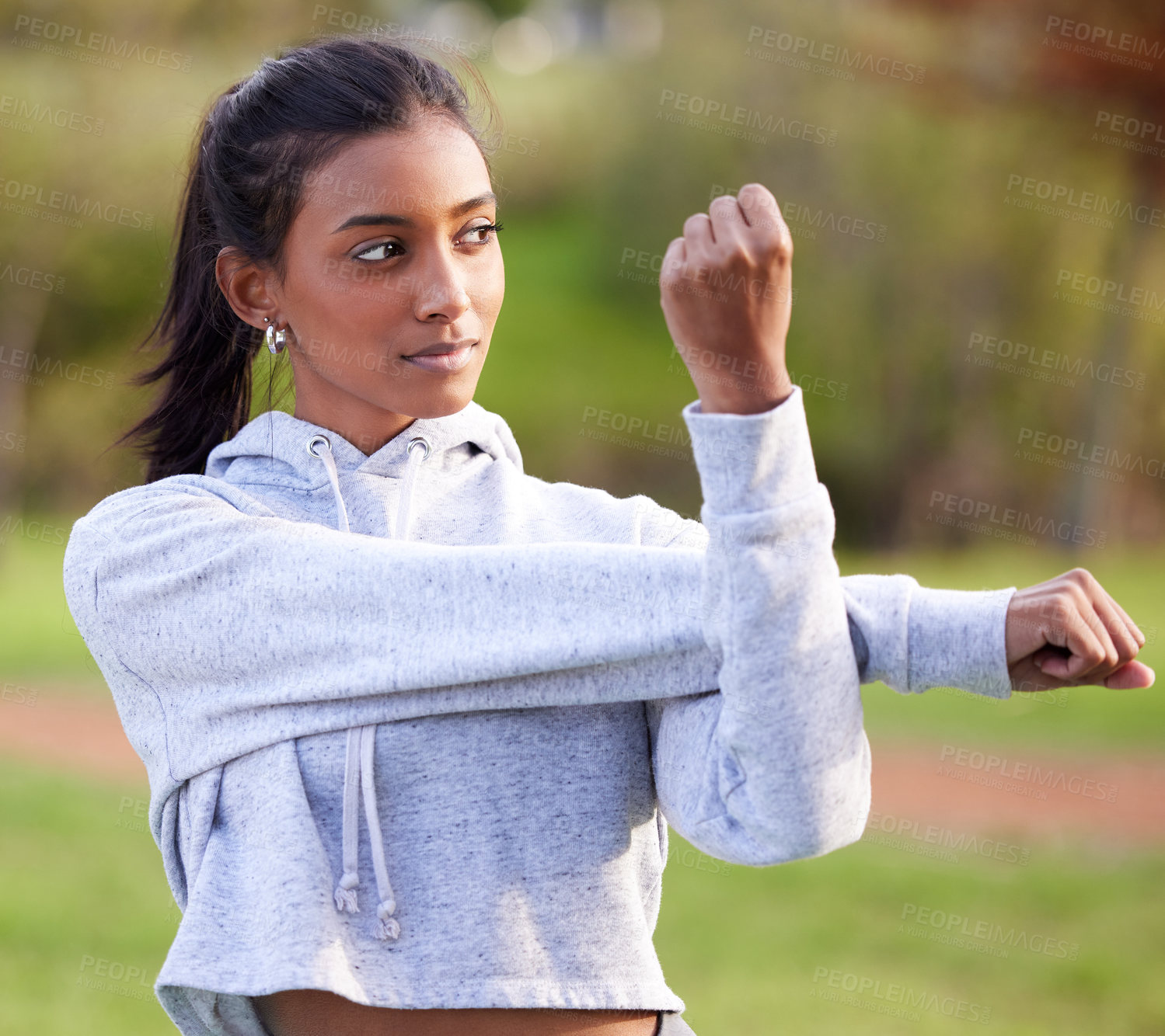 Buy stock photo Yoga, park and Indian woman stretching arms for wellness, healthy body and warm up for sports in nature. Pilates, fitness and person outdoors for exercise, marathon training and workout for running