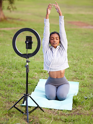Buy stock photo Influencer, girl and phone for yoga in outdoors, recording and meditation for vlog or live streaming. Woman, zen and tutorial or pilates and spiritual awareness in nature park and filming fitness
