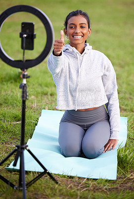 Buy stock photo Woman, yoga and recording with phone in park for thumbs up, yes and fitness with smile on live stream. Girl, person or virtual personal trainer with emoji, symbol or like icon with ring light on lawn