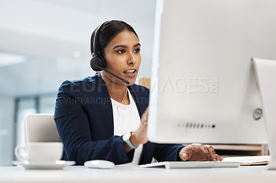Buy stock photo Shot of a young businesswoman working on a computer in a call centre