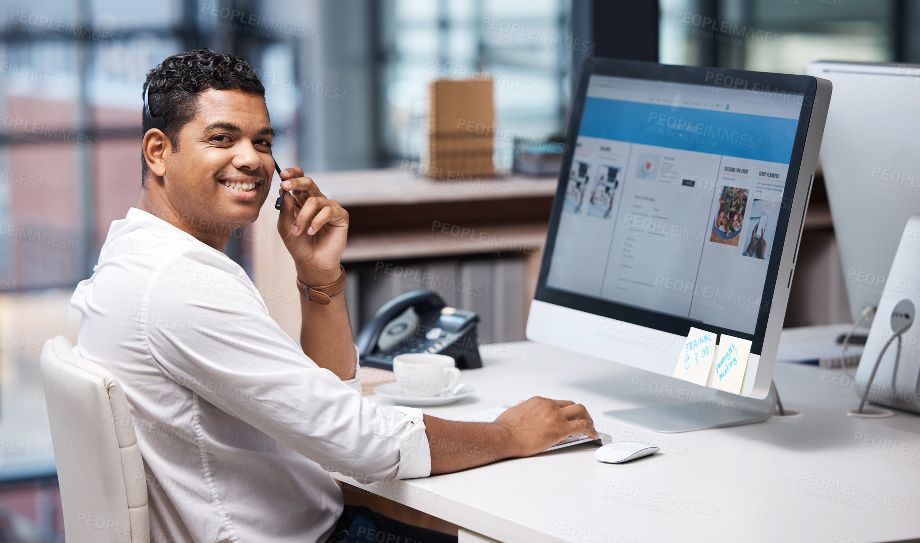 Buy stock photo Portrait of a young businessman working on a computer in a call centre