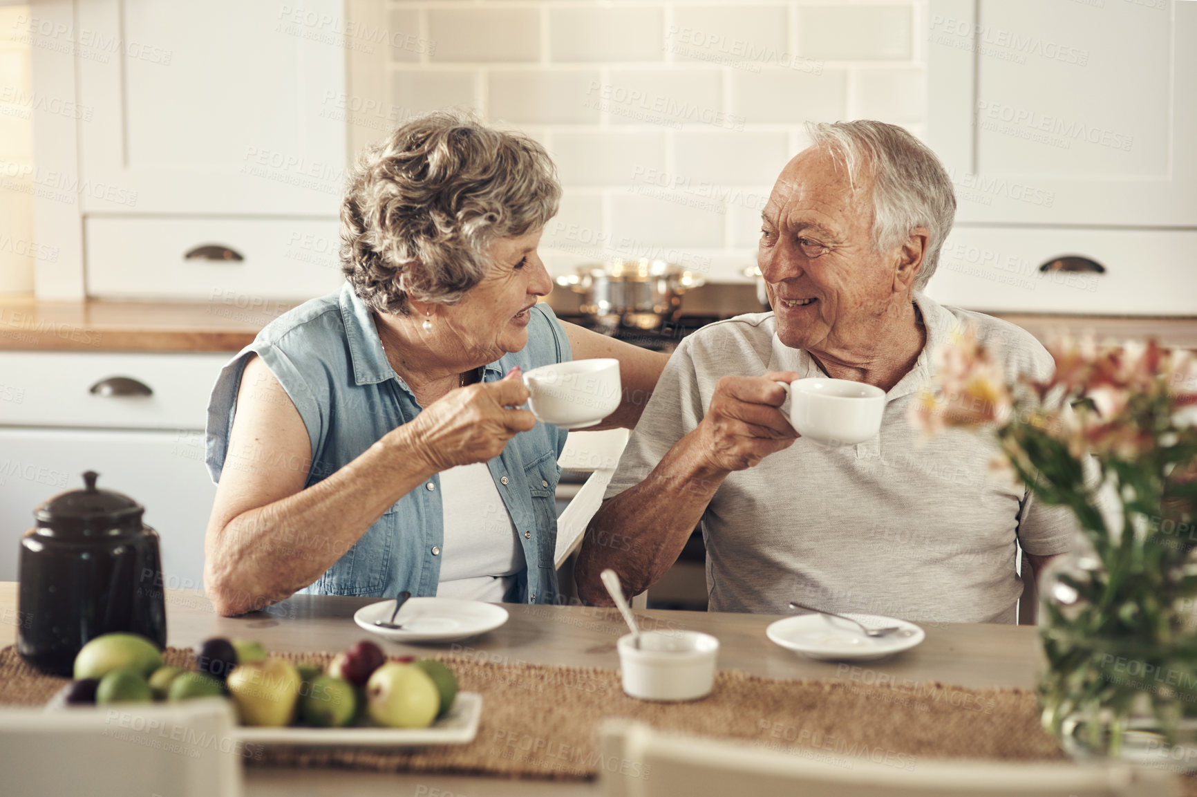 Buy stock photo Shot of a senior couple having breakfast together at home