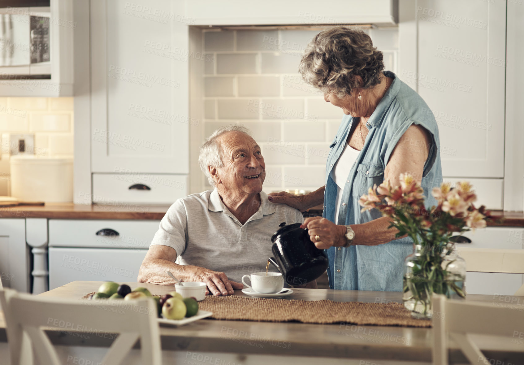 Buy stock photo Shot of a senior couple having breakfast together at home