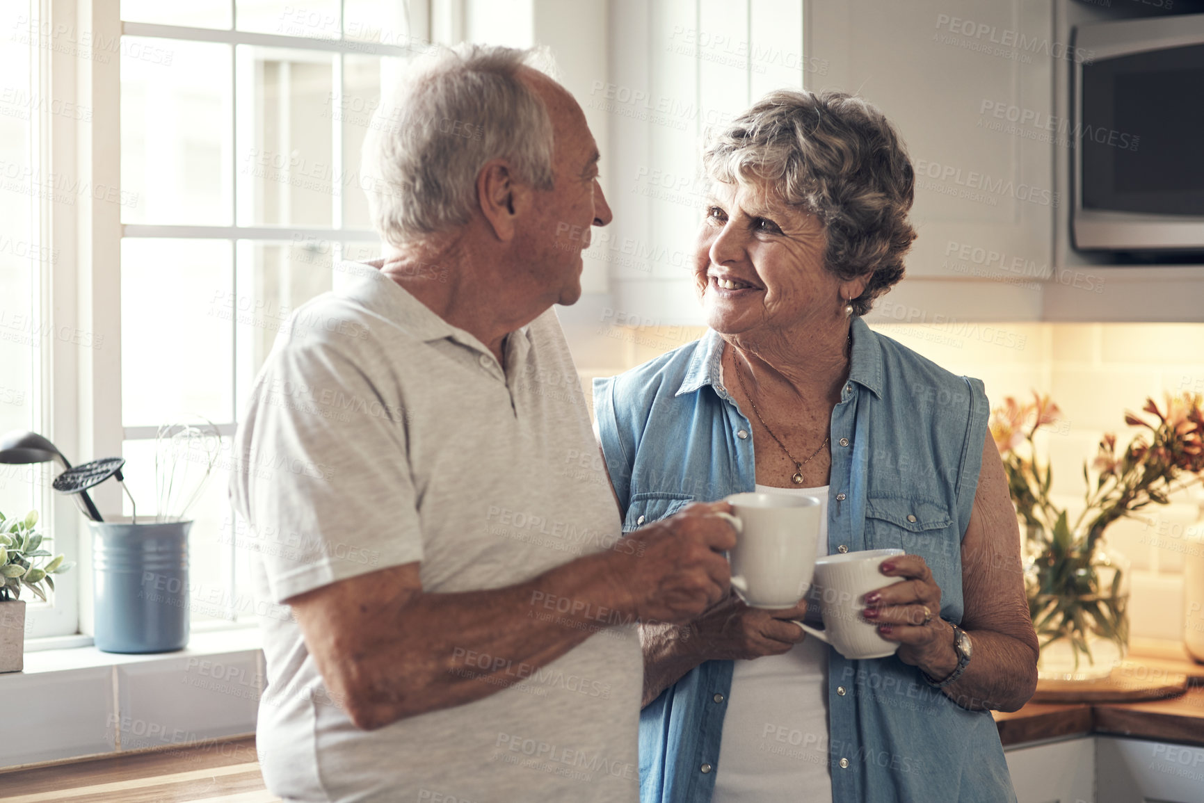 Buy stock photo Shot of a senior couple having breakfast together at home