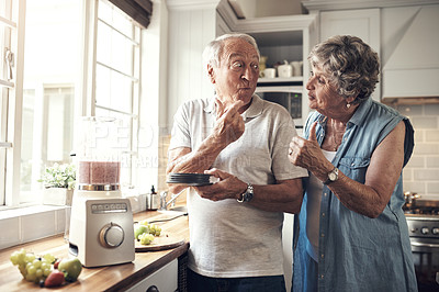 Buy stock photo Shot of a senior couple making a smoothie in the kitchen at home