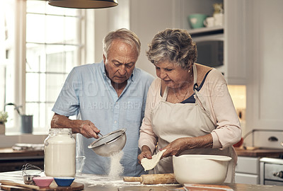 Buy stock photo Shot of a senior couple baking together at home