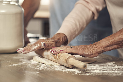 Buy stock photo Shot of an unrecognizable couple baking together at home