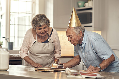 Buy stock photo Shot of a senior couple celebrating a birthday at home