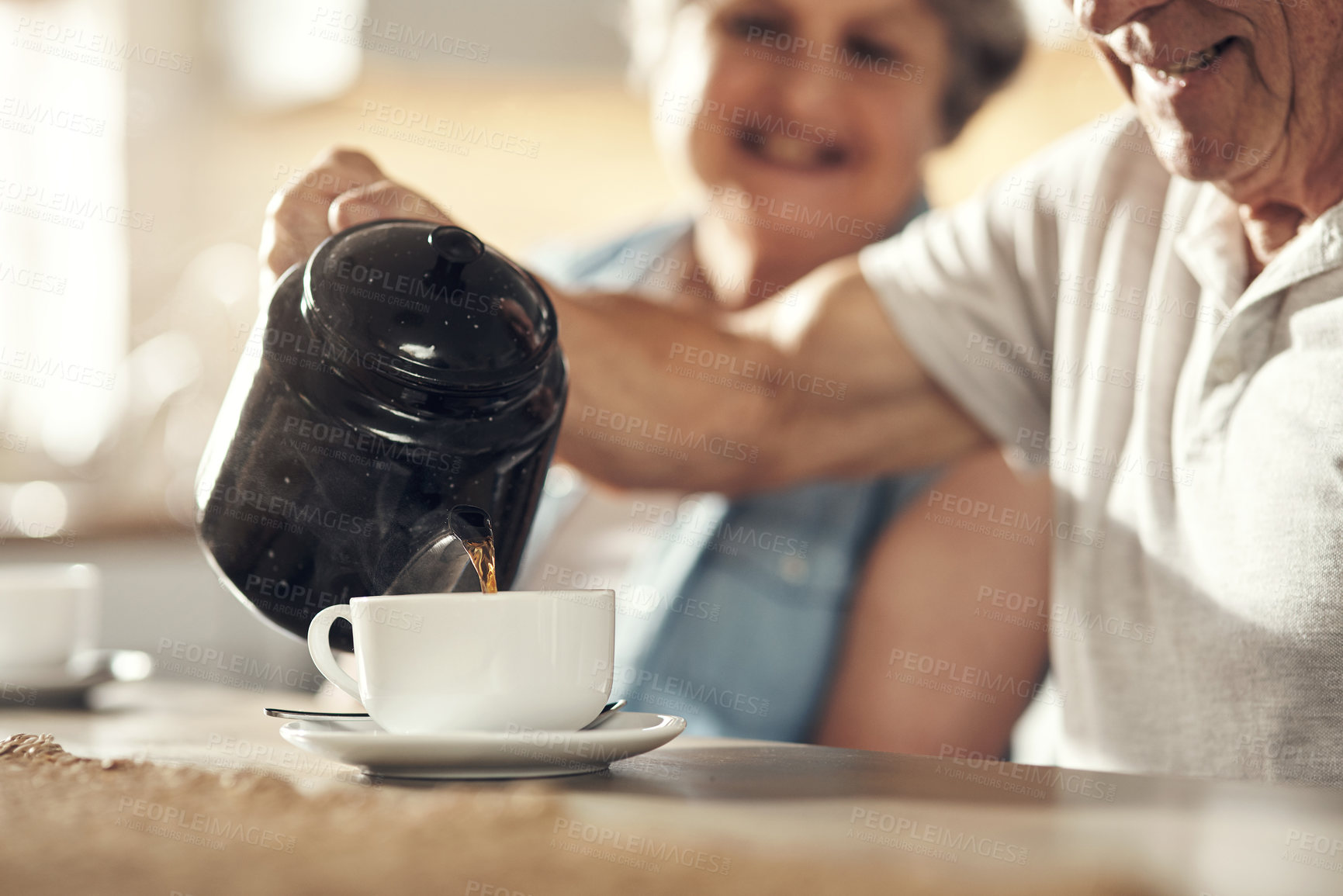 Buy stock photo Shot of a senior couple having breakfast together at home