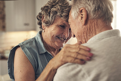 Buy stock photo Shot of a senior couple embracing at home