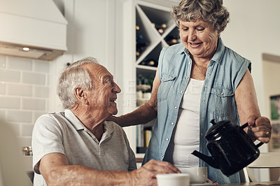 Buy stock photo Shot of a senior couple having breakfast together at home