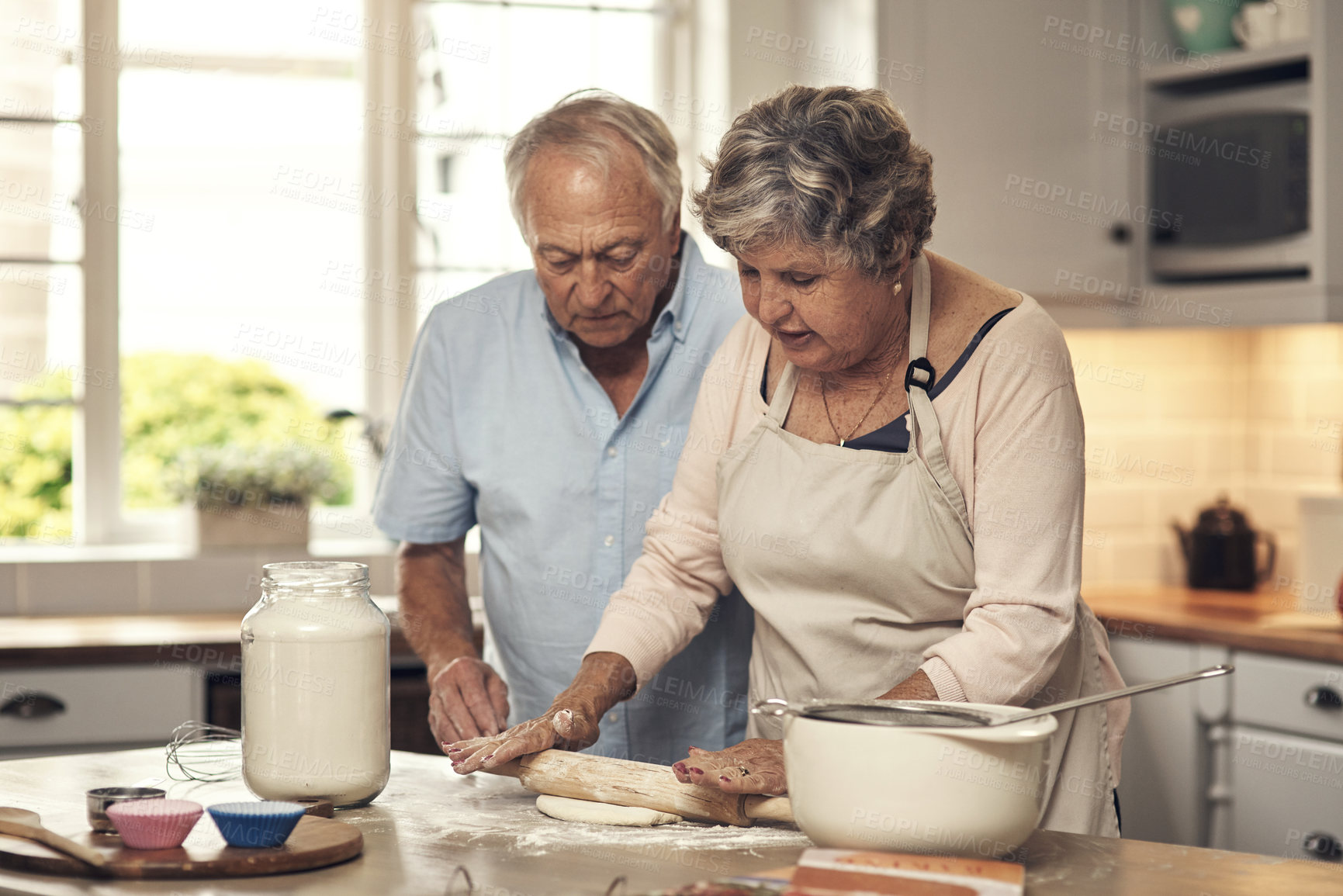 Buy stock photo Shot of a senior couple baking together at home