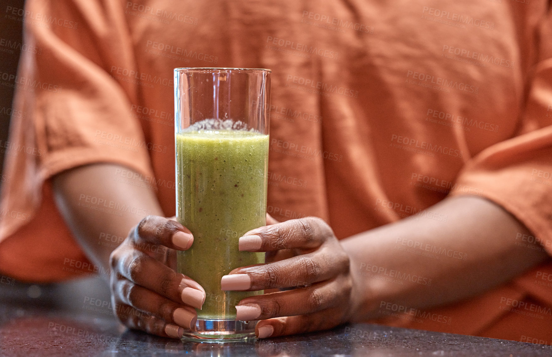 Buy stock photo Hands, drink and woman with smoothie in home for healthy diet, nutrition or wellness at table in kitchen in the morning. Glass, organic or green juice for vegan cocktail, detox or breakfast closeup