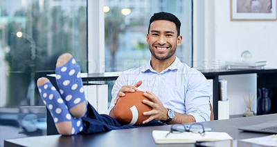 Buy stock photo Portrait of a young businessman holding a ball at his desk at work