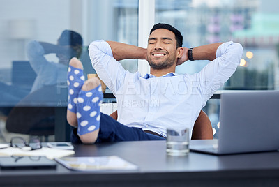 Buy stock photo Shot of a very satisfied businessman relaxing at his desk at work