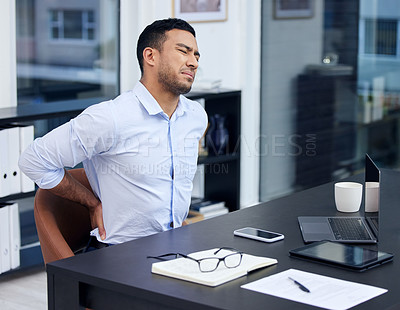 Buy stock photo Shot of a businessman suffering from backache at work