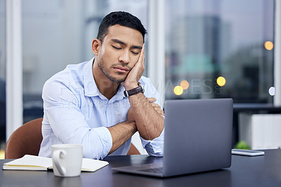 Buy stock photo Shot of a businessman looking exhausted at work