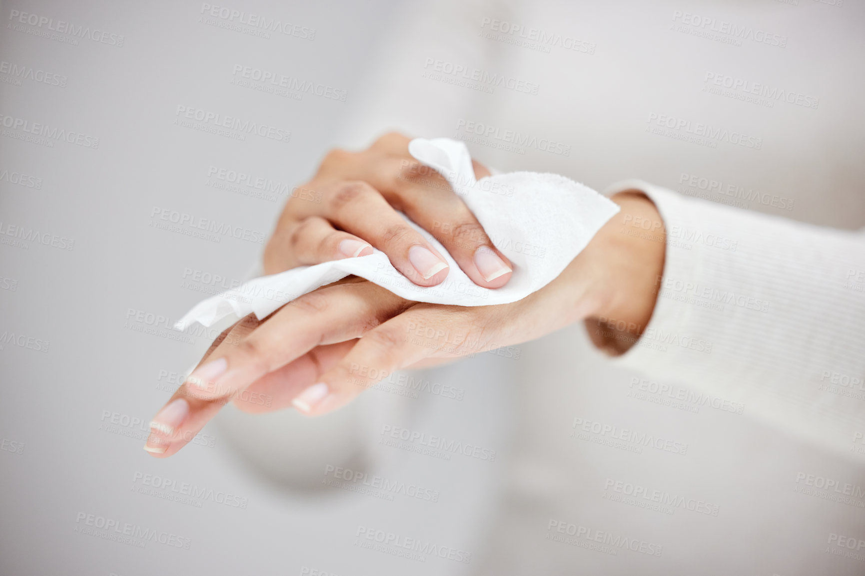 Buy stock photo Shot of an unrecognizable person using a wipe to clean their hands