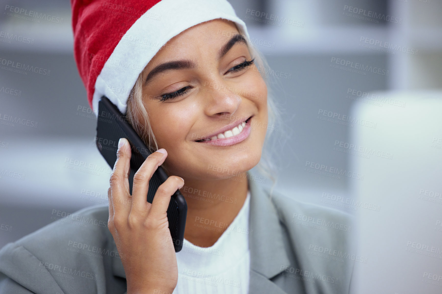 Buy stock photo Shot of a happy young woman enjoying a phone call at the office