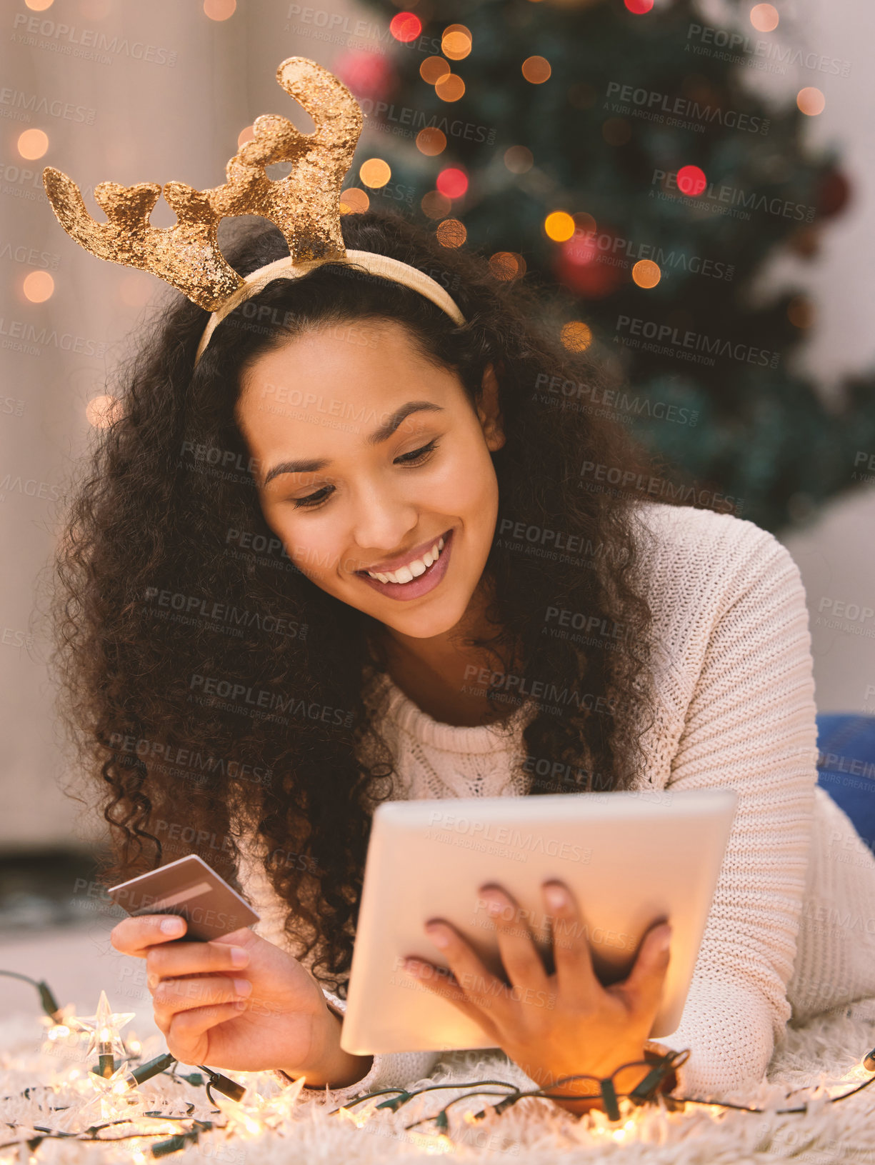 Buy stock photo Shot of a happy young woman using a laptop and credit card during Christmas at home