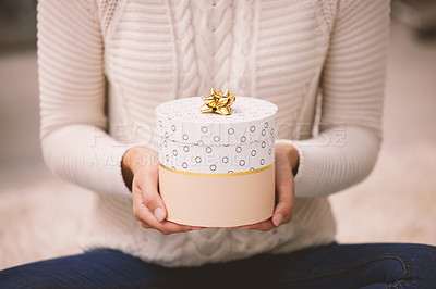 Buy stock photo Shot of an unrecognisable woman opening presents during Christmas at home