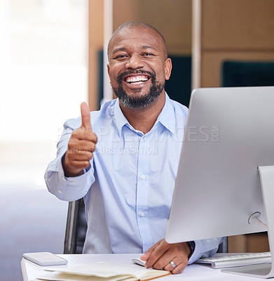 Buy stock photo Shot of a young businessman showing a thumbs up in an office at work