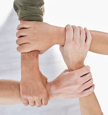 Buy stock photo Shot of a group of colleagues holding arms