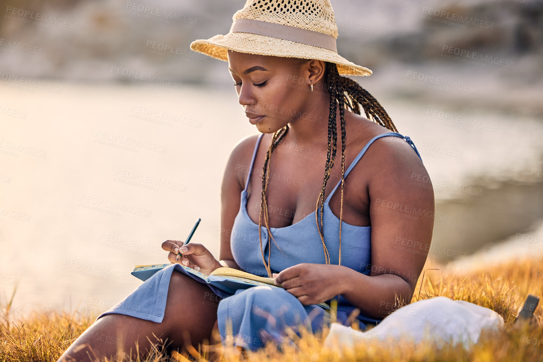 Buy stock photo Sunset, notebook and black woman journaling in nature to relax on vacation, adventure or holiday. Mental health, ideas and African female person writing notes, feelings or emotions on weekend trip.