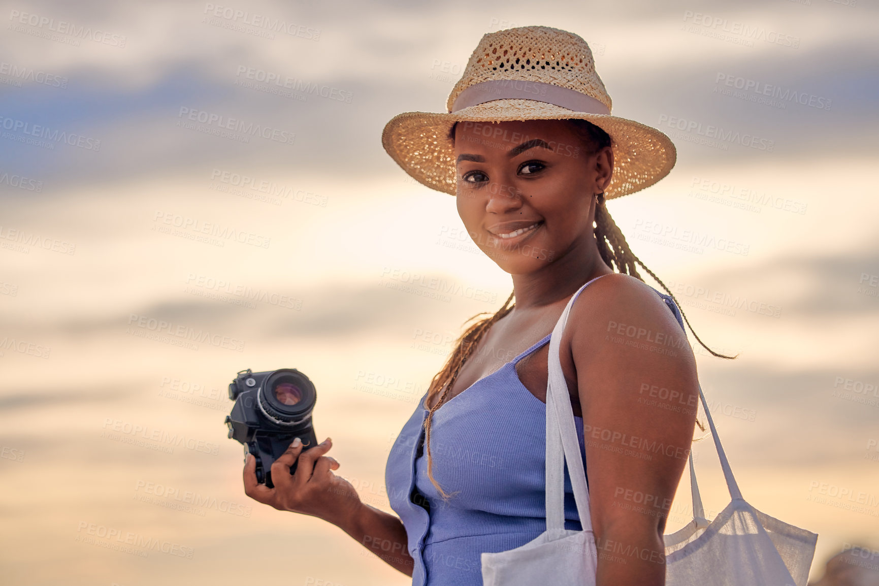 Buy stock photo Photographer, sunset or portrait of black woman with camera on holiday vacation or break in Greece. Tourist, girl or African person with smile or sky at nature for picture, photography and travel