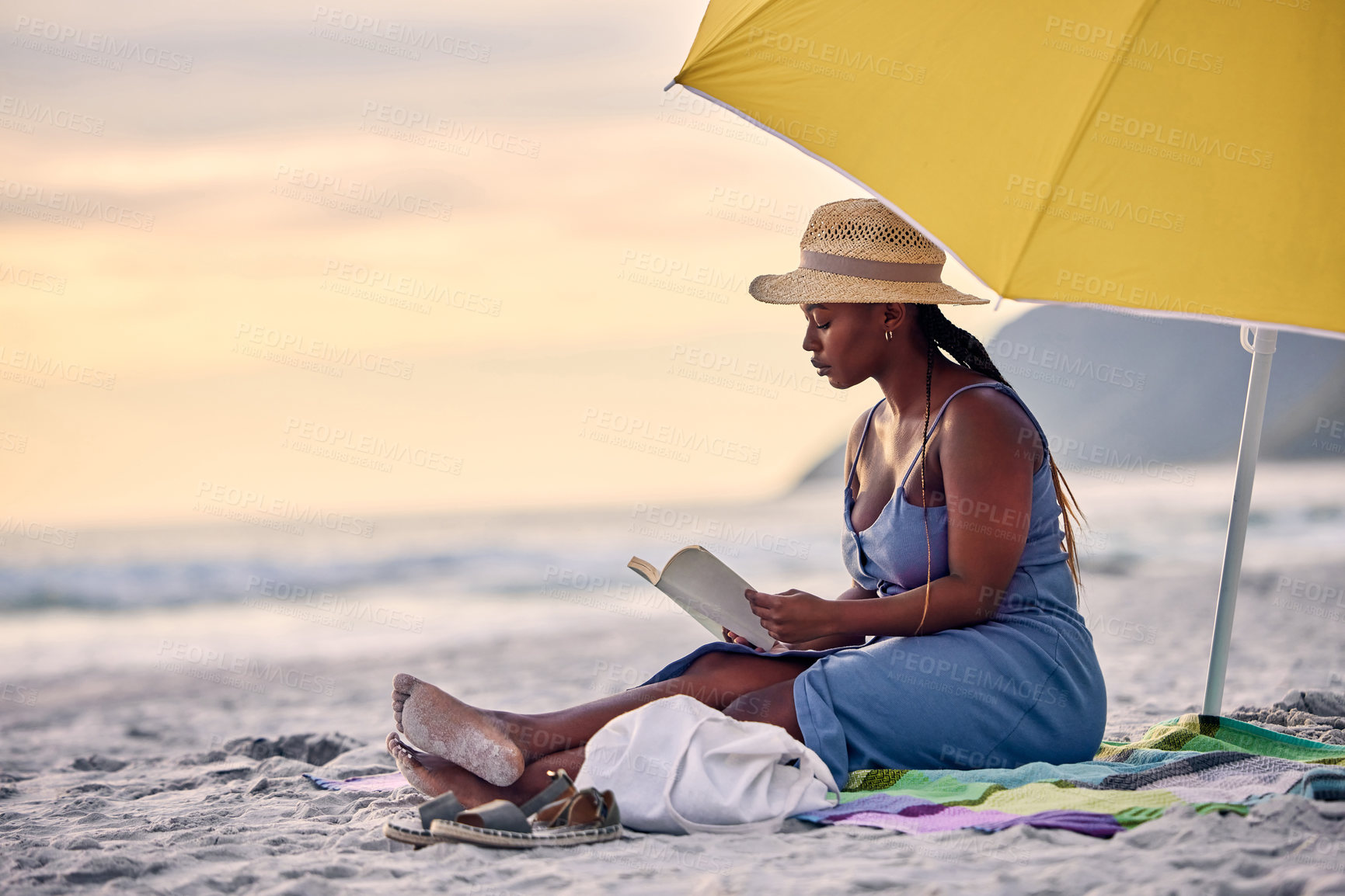 Buy stock photo Sunset, relax or black woman reading book at sea for alone time, rest break or holiday vacation. Beach, travel or African person with fiction story or novel for knowledge, peace or hobby in Greece